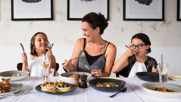 Julia Lipari and her daughters, Isabella (left) and Lily (right) dig in at  Otto in Woolloomooloo. 