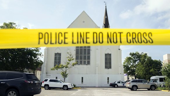 Police tape surrounds the parking lot behind the AME Emanuel Church as FBI forensic experts work at the crime scene after the shooting. 