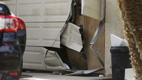 A garage door of Enrique Marquez's home is broken in after an FBI raid, in Riverside, California, in December 2015.