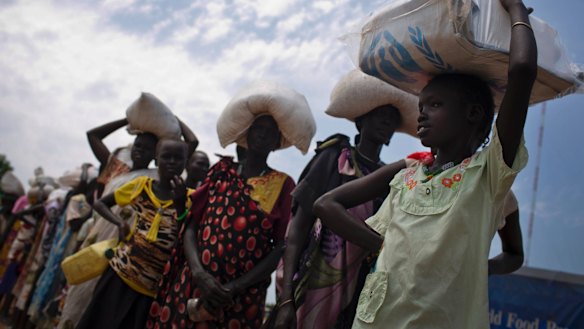 A young girl who fled fighting queues for food aid at a food distribution made by the World Food Programme in Bentiu, South Sudan.