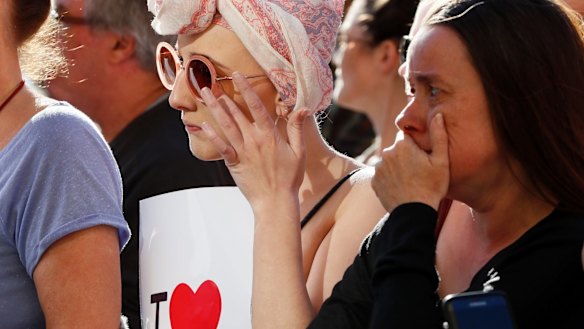 People attend a vigil in Albert Square, Manchester, England.