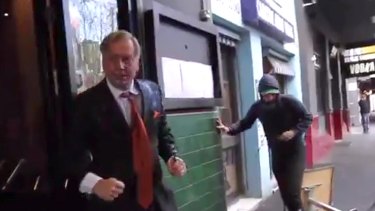 Andrew Bolt fights back against assailants on the streets of Carlton in Melbourne.