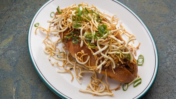 Mapo tofu and noodle bun with fried noodles and spring onion.