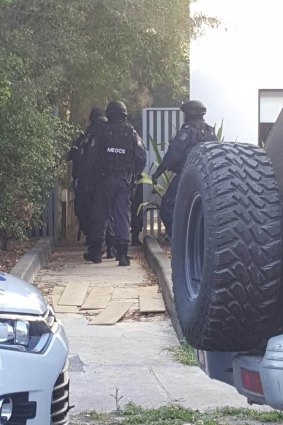 Middle Eastern Organised Crime Squad officers raid Kemel Barakat's unit at Mortlake in December.