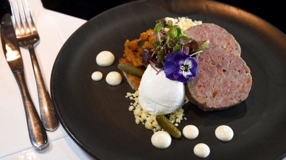 Pucks of pork and rabbit terrine served with pineapple chutney and poached egg.