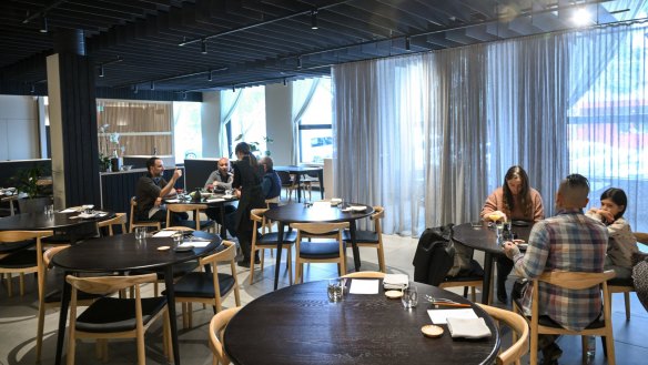 Komeyu's elegant dining room with well-spaced round tables.