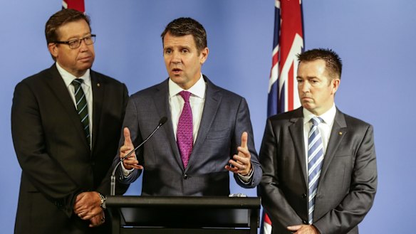The greyhound ban is weighing heavily on Deputy Premier Troy Grant, left, and Premier Mike Baird. 