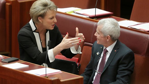 Employment Minister Michaelia Cash speaks with Senator Roberts.
