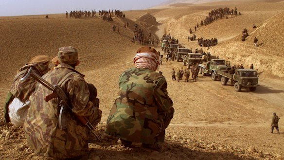 Taliban fighters leaving Kunduz province in 2001: Now, they are back and threatening to overrun parts of the provincial capital.