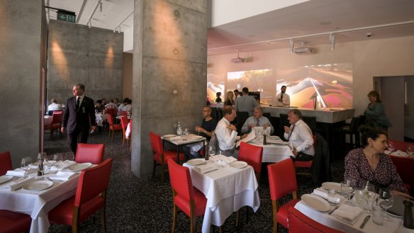 Videos and slashes of vivid red electrify the Di Stasio Citta dining room.