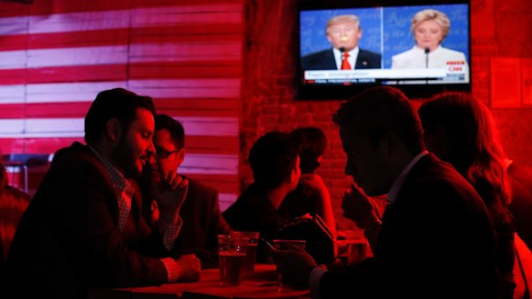 Customers watch the US presidential debate at the Pinche Gringo BBQ restaurant in Mexico City.