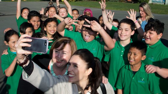 Ardern poses for a selfie with students in Christchurch.