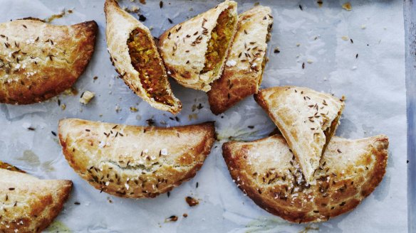 Spiced lentil and vegetable pasties sprinkled with cumin seeds.