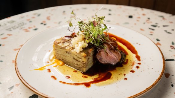 Pan-seared duck breast with baked potato terrine and carrot puree.