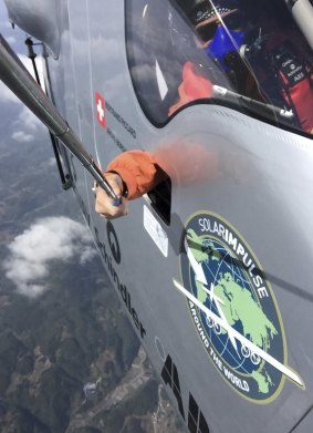 Say cheese: Swiss pilot Bertrand Piccard uses a selfie stick to take a photo from his Solar Impulse 2 cockpit during the sixth leg of his round-the-world trip.