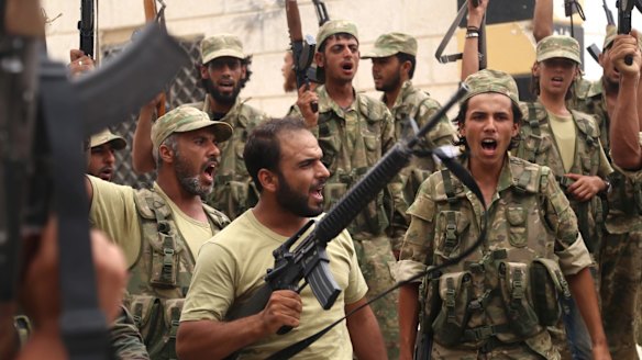 Free Syrian Army fighters, who have been backed by Turkish tanks and air support,  celebrate in Jarablus after driving out Islamic State.