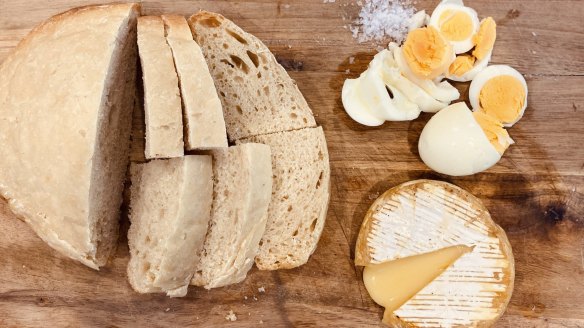 Clockwise from top right: Air-fried hard-boiled eggs, a wheel of camembert cooked in an air fryer and bread baked in a slow cooker.