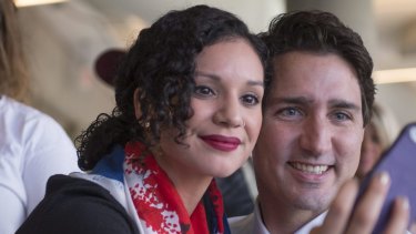 Liberal Leader Justin Trudeau poses for a photograph with a student while touring Mohawk College, in Hamilton, Ontario.