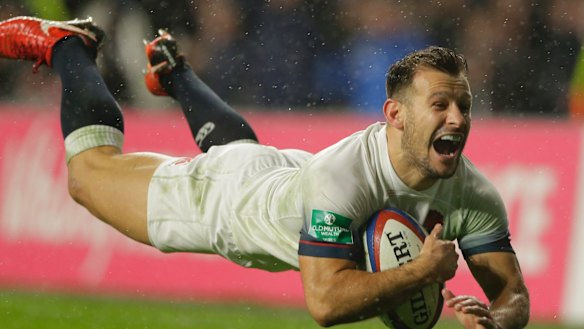 England's Danny Care smiles as he goes over the line for England's fourth try.