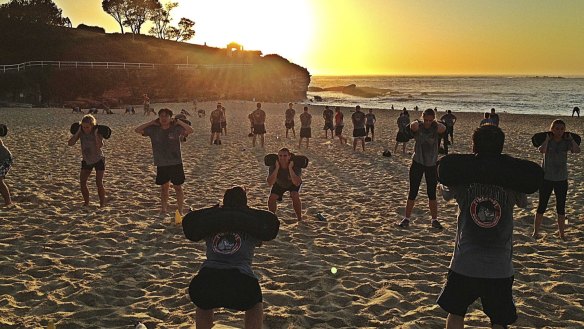 Joining other bootcampers for a workout on the beach.