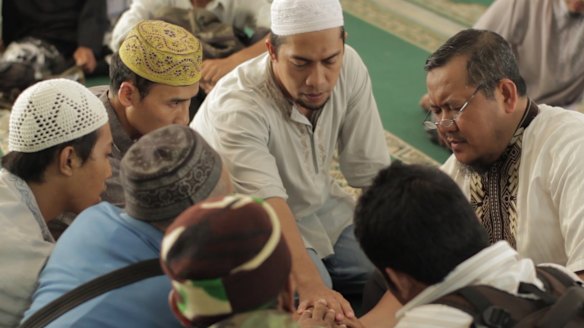 Fauzan al-Anshori, right, an Islamic State recruiter, leads the "bayat", an oath of devotion, to the leader of Islamic State.  