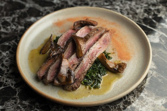 Wagyu flank from Jack's Creek is made autumnal with pan-roasted pine mushrooms and braised kale.