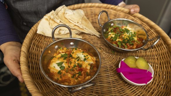 Shakshuka and pickles served at Flavours of Syria cafe in St Kilda.