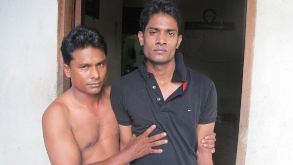 Mohammed Rosshad (right) is helped by his friend Mohammed Yusuf.
