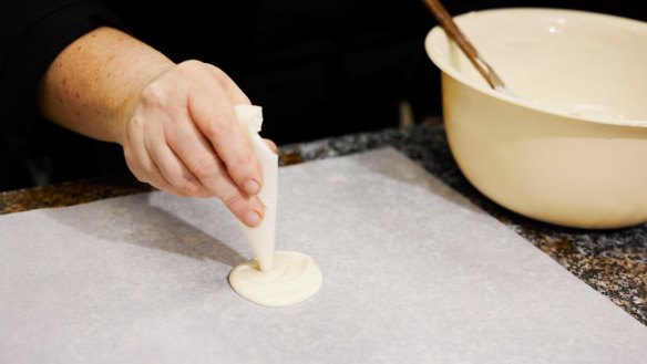 Piping the white chocolate 'egg whites'.