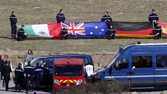The Australian flag is displayed at a ceremony to pay tribute March 30, 2015 to the two Australians among 150 victims of the Germanwings Airbus A320.