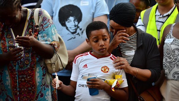 People attend a candlelight vigil outside Notting Hill Methodist Church near the Grenfell Tower block.