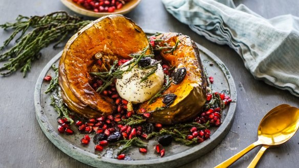 Festive roast pumpkin decorated with samphire, pomegranate and burrata.