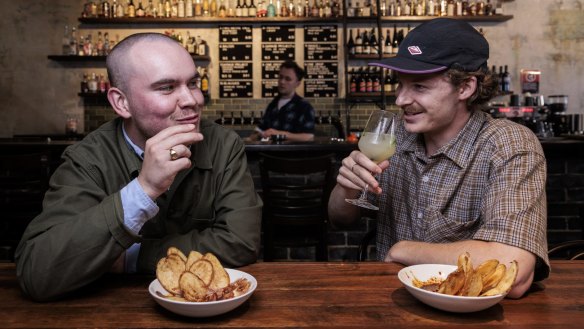 Darcy and Remi enjoy Odd Culture's Tepache spritz cocktail potato chips with chicken liver pate.