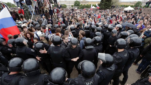 Police form a human chain during an anti-corruption rally in St Petersburg, Russia.