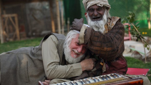 Gittoes with a Sufi singer in the yard of the Yellow House.
