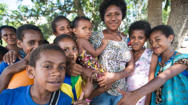 Mother Martina and daughter Angeline, centre, with other children at the Nine Mile settlement outside Port Moresby.