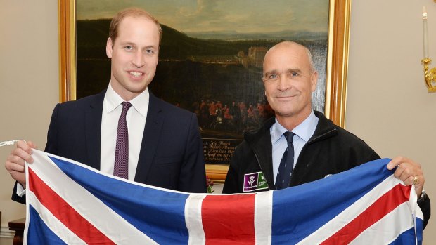 British adventurer Henry Worsley, right, with Britain's Prince William as they hold the British flag in London. Worsley has died after suffering exhaustion and dehydration while attempting to cross the Antarctic alone.