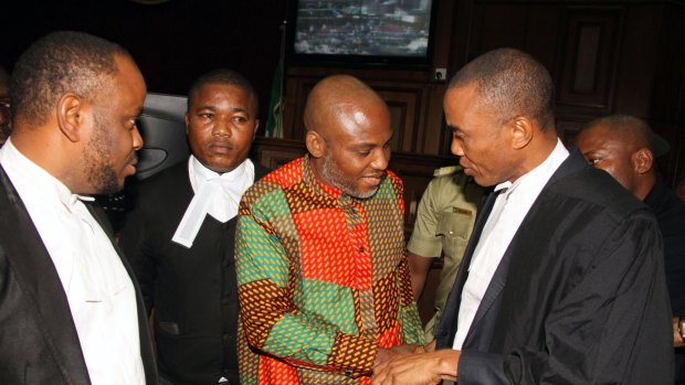 Biafran separatist leader Nnamdi Kanu, centre, speaks to his lawyers at the Federal High Court in Abuja, Nigeria, on Friday.