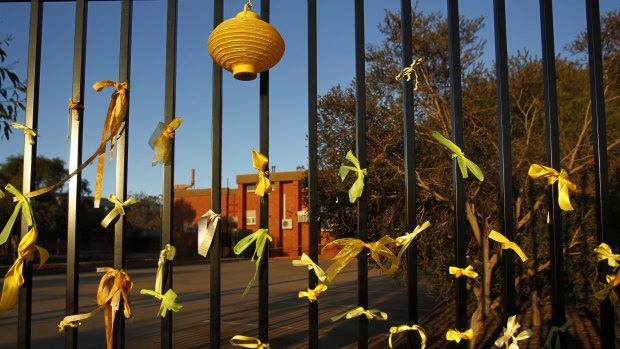 Yellow ribbons tied to the fence of Leeton High School for murdered teacher Stephanie Scott.
