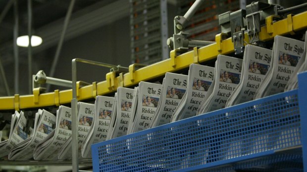 Time change: the broadsheet edition of the Herald on the printing press.