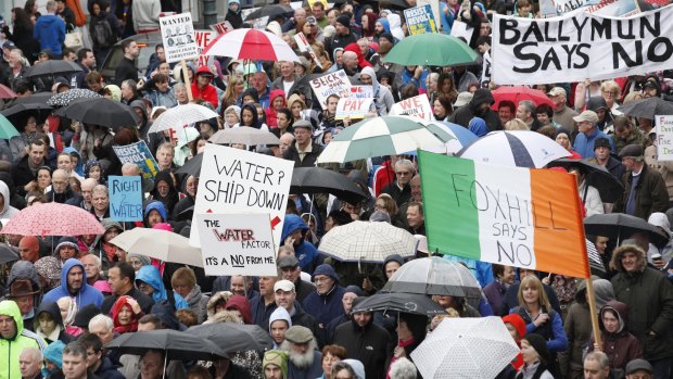 Damp reception: Protesters march against Ireland's new tax on water earlier this month.
