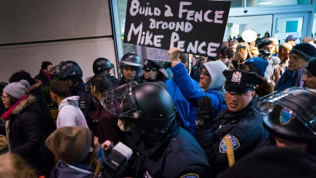 Protesters are surrounded by police at John F. Kennedy airport in New York.