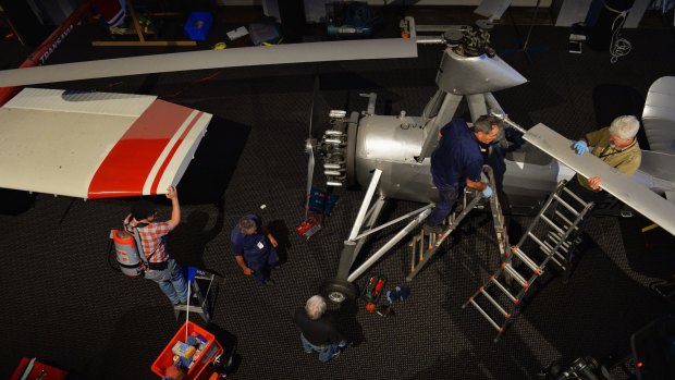 Powerhouse Museum staff take apart an autogiro and a Transavia Airtruk. 