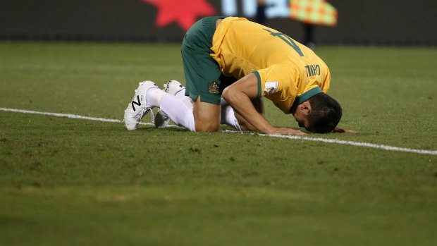 Tim Cahill uses his head to flatten out the 'bumpy'  Canberra Stadium surface.