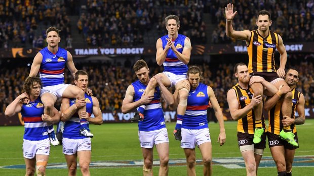 When legends leave: Matthew Boyd, Robert Murphy and Luke Hodge are chaired from the ground after the  Western Bulldogs-Hawthorn match at Etihad Stadium on Friday night.