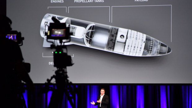 Elon Musk, and behind him a design for space transport, is seen during a presentation at the International Astronautical Congress in Adelaide.