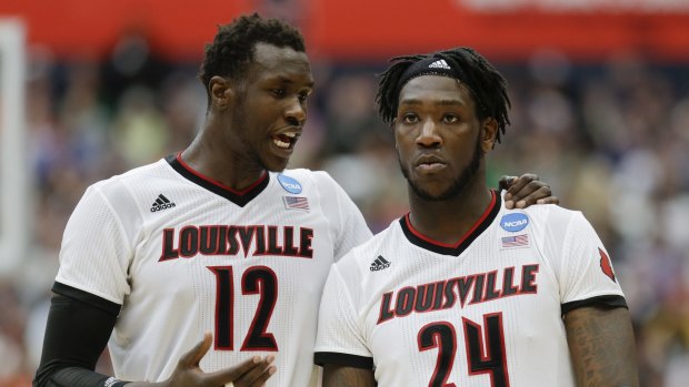 Louisville's Mangok Mathiang (left) hit one free throw but missed the second..