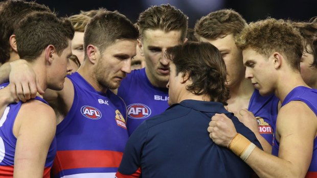 Inspirational? Luke Beveridge had a moment with his team and the premiership cup.