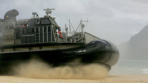 A US Navy landing craft air cushion amphibious vehicle storms the beach at Bellows Air Force Station on Oahu, Hawaii.