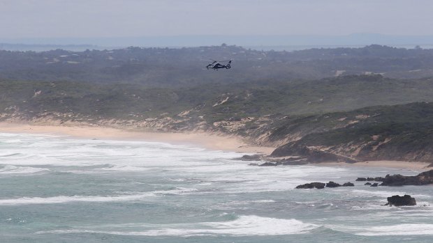 A search and rescue helicopter hovers off Fingal Beach.